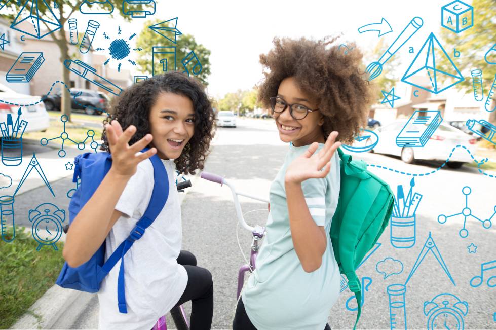 two students with backpacks waving